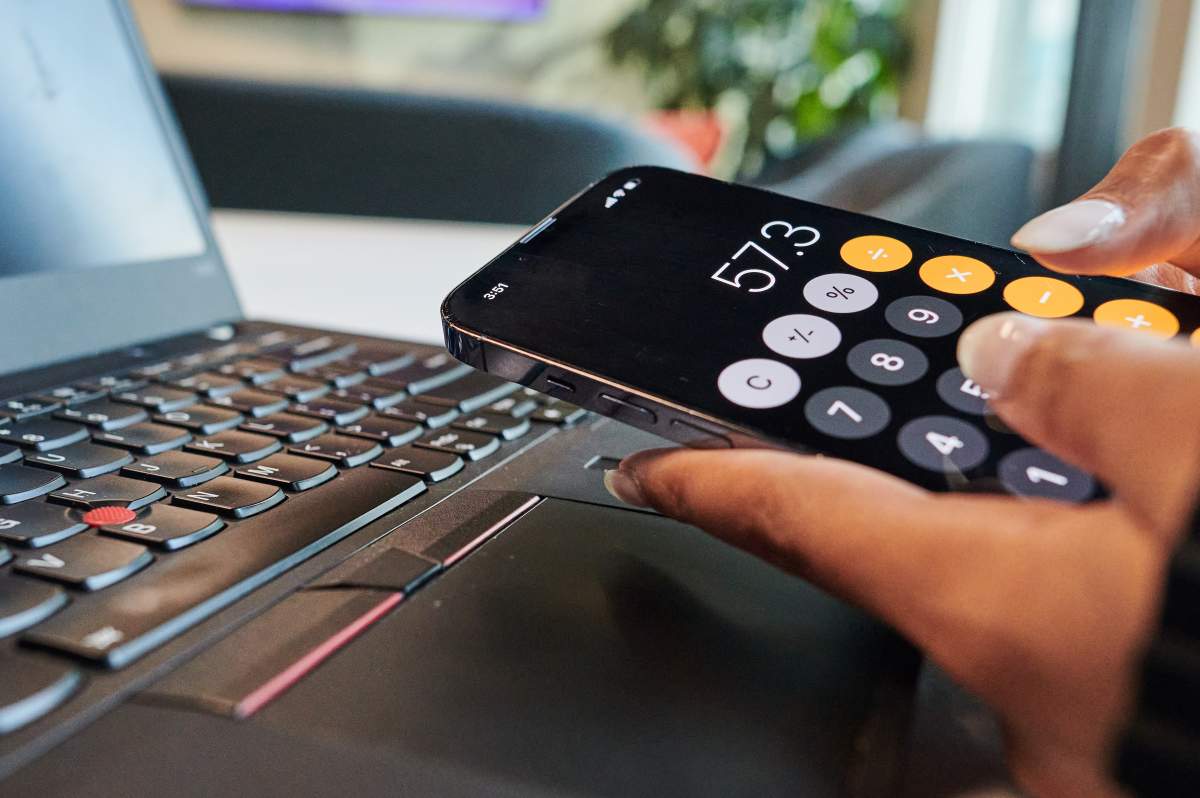 A person uses the calculator app on their phone in a photo illustration made in Toronto, on Monday, Sept. 22, 2025.