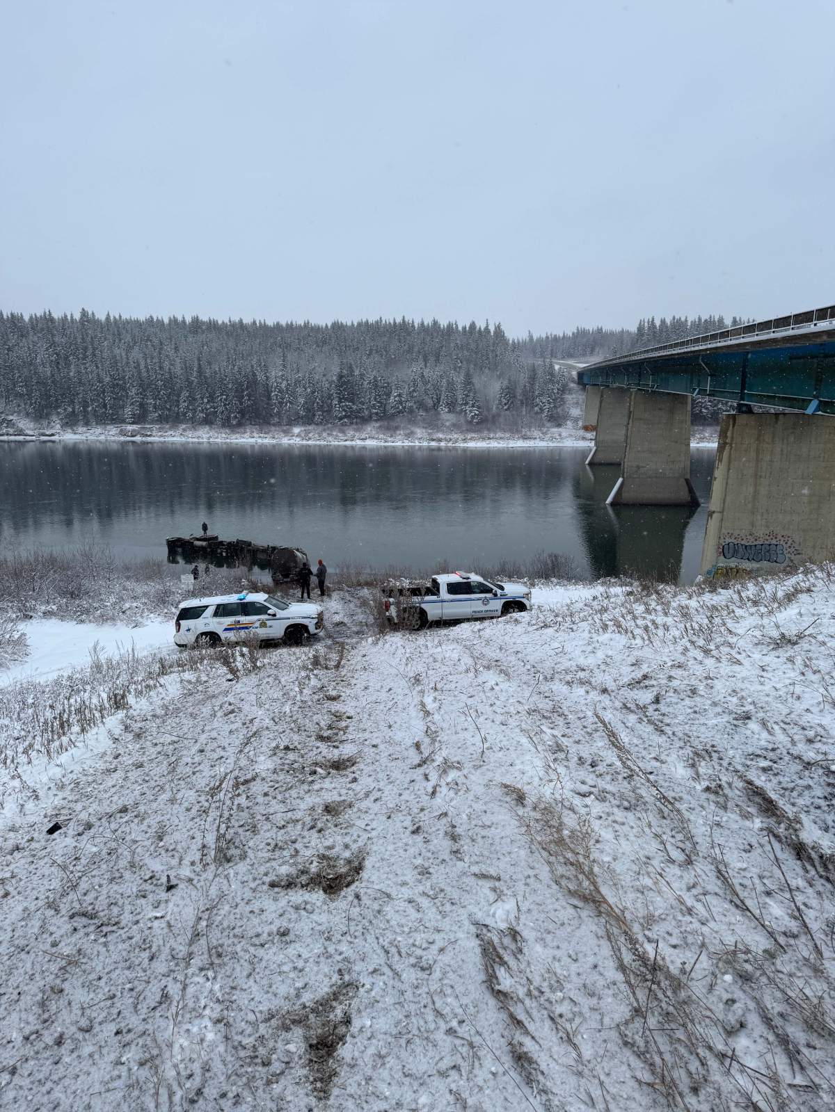A tanker trailer hauling suspected bitumen lost control on an icy highway and crashed into the North Saskatchewan River near Waskatenau, downstream of Edmonton, on Thursday, Nov. 6, 2025.