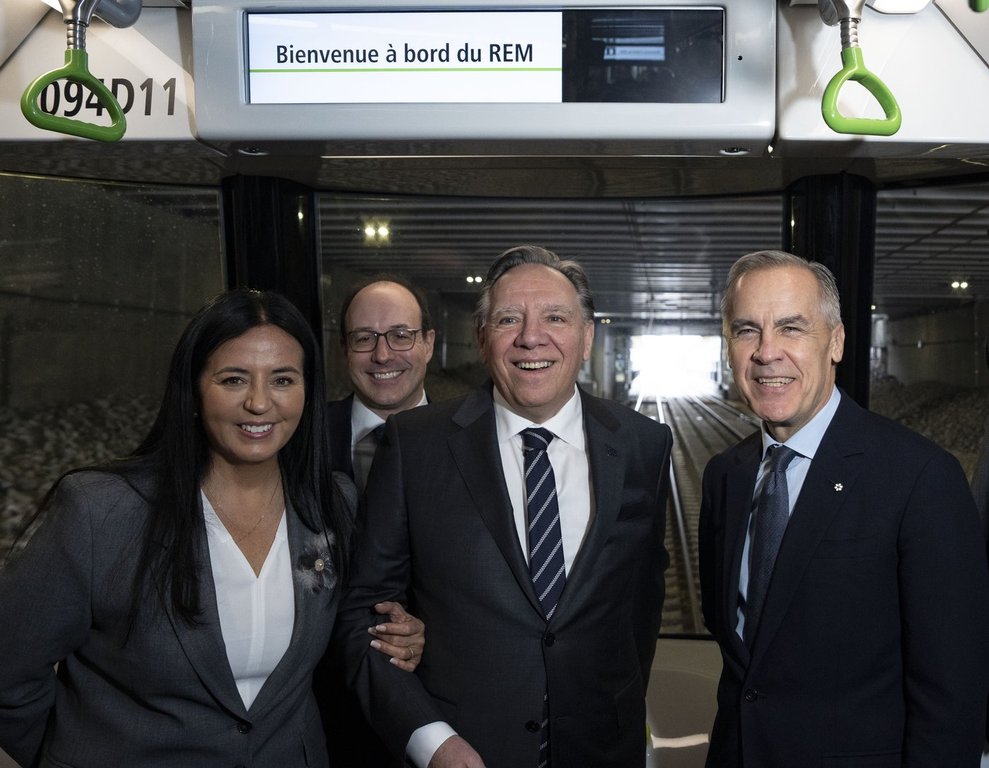 Prime Minister Mark Carney, right, Montreal mayor Soraya Martinez Ferrada, left, CEO of La Caisse Charles Emond, second left, and Quebec Premier Francois Legault ride the REM light rail system on its inaugural run connecting McGill station in downtown Montreal to Deux-Montagnes, Quebec in Montreal on Friday, Nov. 14, 2025.