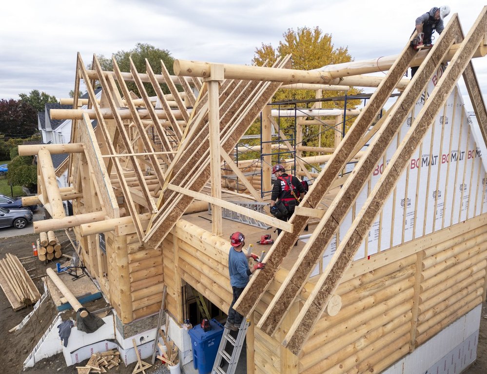 Canada Mortgage and Housing Corp. is expected to release October housing starts figures on Tuesday. An aerial view shows carpenters building a log home made from white pine in Salaberry-de-Valleyfield, Que., on Wednesday, Oct. 22, 2025.