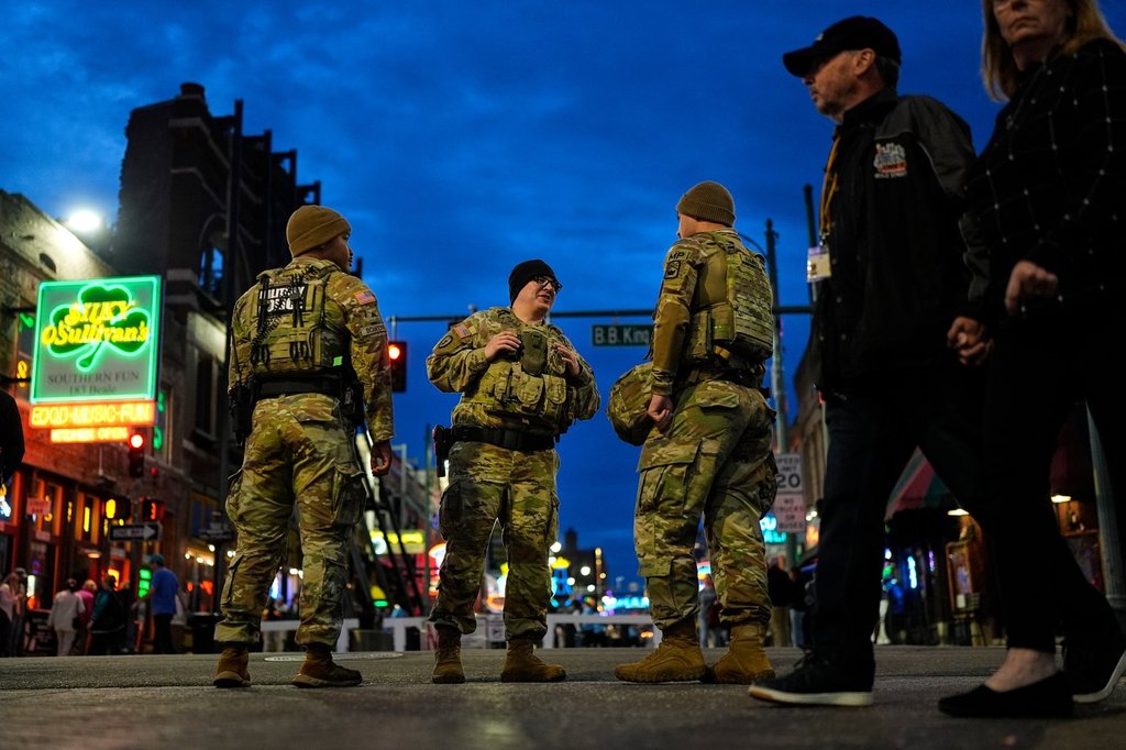 Members of the National Guard stand watch at the intersection of B.B. King Blvd. and Beale Street, Friday, Oct. 24, 2025, in Memphis, Tenn. (AP Photo/George Walker IV)
