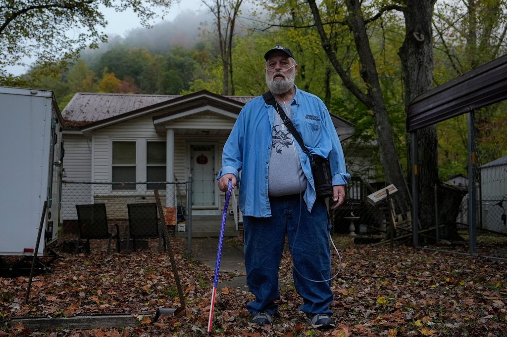 Randy Lawrence, president of the Kanawha County Black Lung Association, stands outside his home wearing supplemental oxygen for black lung disease near Cabin Creek, W.Va., Oct. 13, 2025. (AP Photo/Carolyn Kaster).