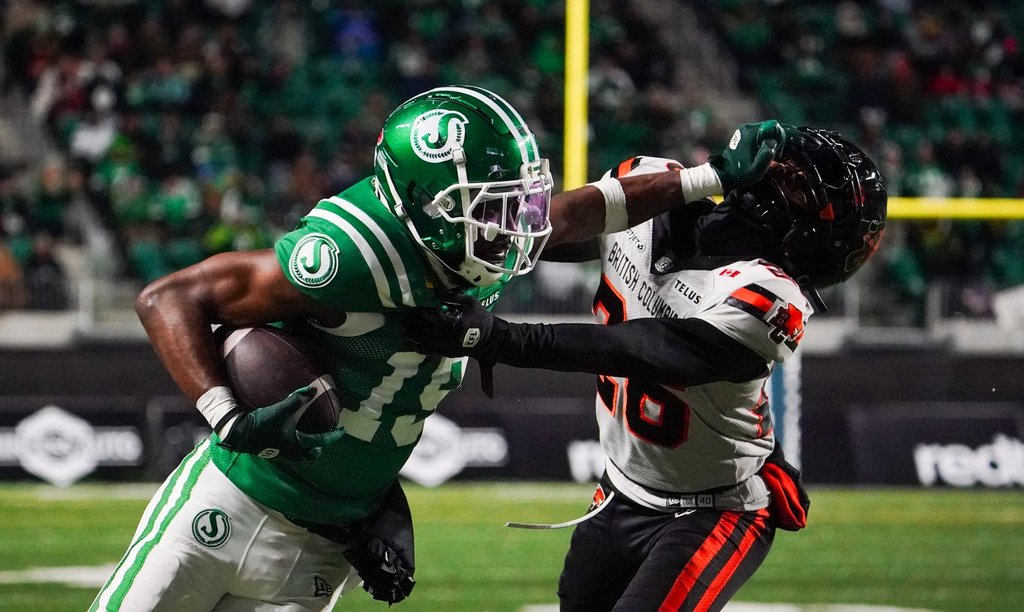 Saskatchewan Roughriders receiver Samuel Emilus (19) stiff arms B.C. Lions defensive back Robert Carter Jr. (26) during the second half of the CFL West Division final football action in Regina, on Saturday, November 8, 2025. THE CANADIAN PRESS/Heywood Yu.
