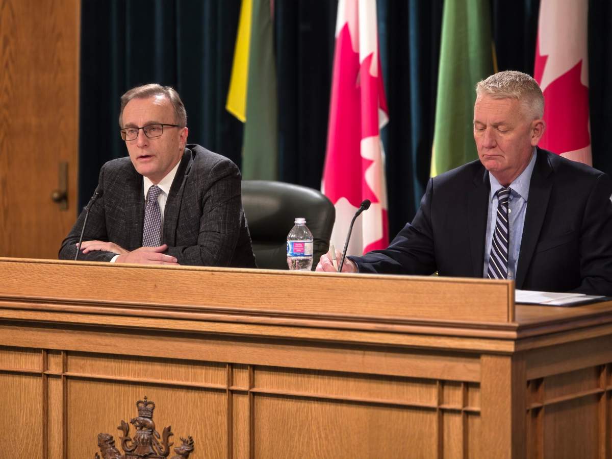 Saskatchewan finance minister Jim Reiter and deputy finance minister Max Hendricks speak at the provincial legislature on Tuesday, Nov. 25, 2025.