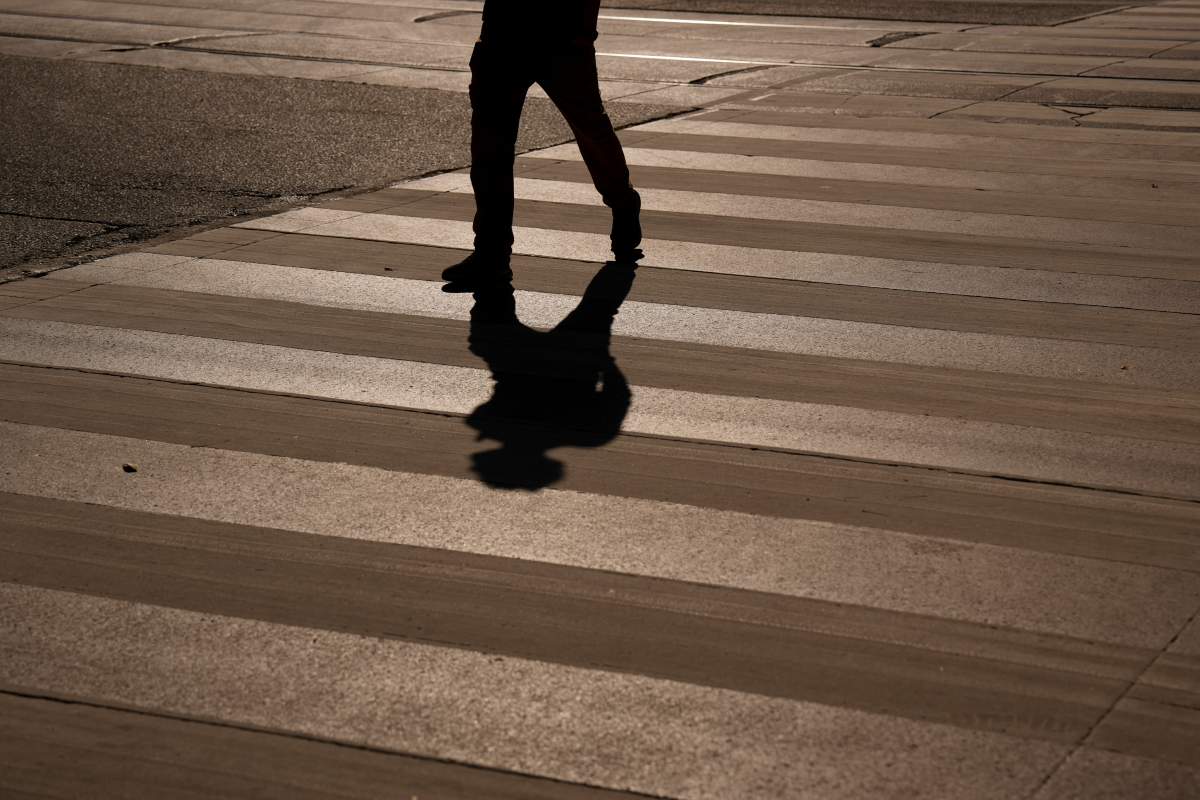 A pedestrian crosses a crosswalk on Wednesday, Oct. 8, 2025. 