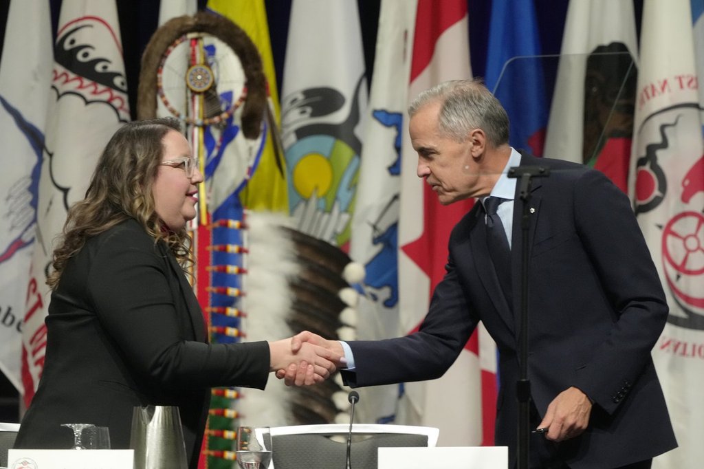 Prime Minister Mark Carney shakes hands with AFN National. hired Cindy Woodhouse Nepinak following his speech at the Assembly of First Nations Special Chiefs Assembly, in Ottawa, Tuesday, Dec. 2, 2025. 