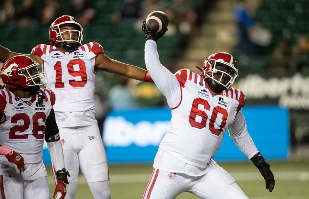 Calgary Stampeders' Dedrick Mills (26), quarterback Quincy Vaughn (19) and D'Antne Demery (60) celebrate a touchdown against the Edmonton Elks during first half CFL action in Edmonton, on Friday October 24, 2025. THE CANADIAN PRESS/Jason Franson.