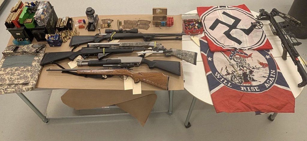 Firearms, ammunition, a crossbow and flags bearing hate symbols, including a swastika and a Confederate flag, are shown in an undated handout photo. THE CANADIAN PRESS/Handout - RCMP.