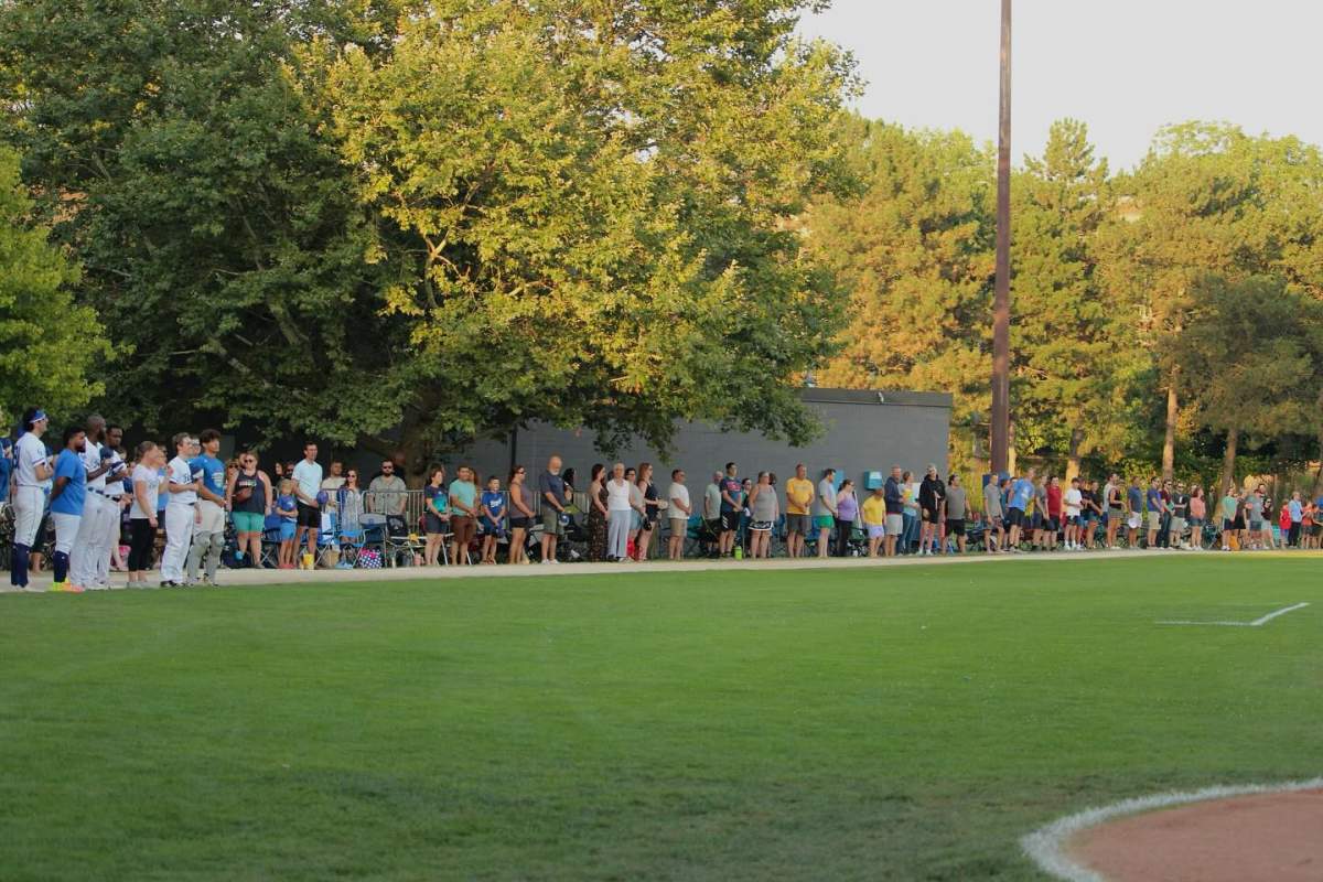 Fans line the edge of the field during a Guelph Royals game.