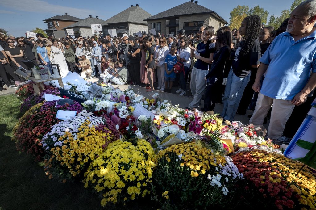 Hundreds of people pass by a memorial for Nooran Rezayi, in Longueuil, Que., Saturday, Sept. 27, 2025. Rezayi, a 15-year-old boy, was shot dead after officers responded to a 911 call about a group of armed young people in a public place in Longueuil.