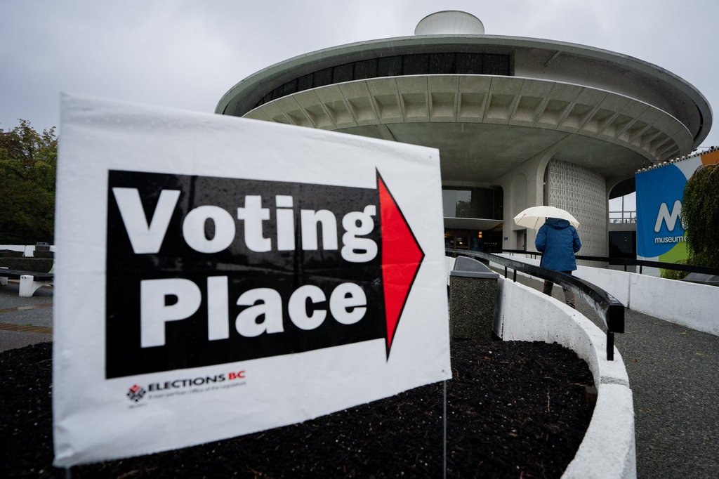 A person walks to a polling station to vote on election day in Vancouver, on Saturday, Oct. 19, 2024. 