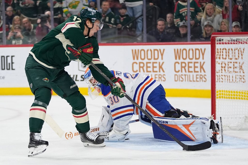 Minnesota Wild left wing Matt Boldy (12) shoots and scores a goal past Edmonton Oilers goaltender Calvin Pickard (30) during the first period of an NHL hockey game, Saturday, Dec. 20, 2025, in St. Paul, Minn. (AP Photo/Abbie Parr).