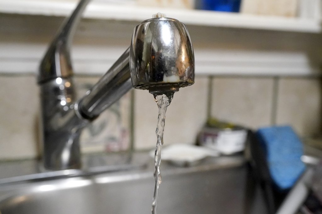 Water pours slowly out of the faucet on Saturday, Feb. 20, 2021, in Dallas. 