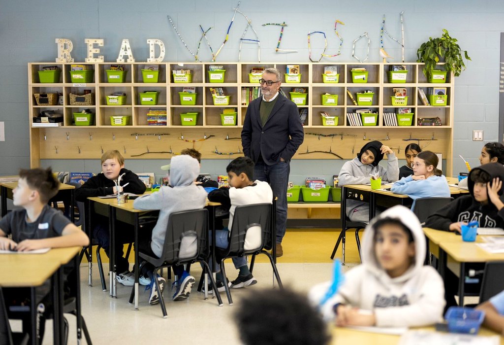 Ontario Education Minister Paul Calandra listens in on a Grade 6 math class as he tours Wazoson Public School after making a funding announcement in Ottawa, on Friday, Dec. 5, 2025.  