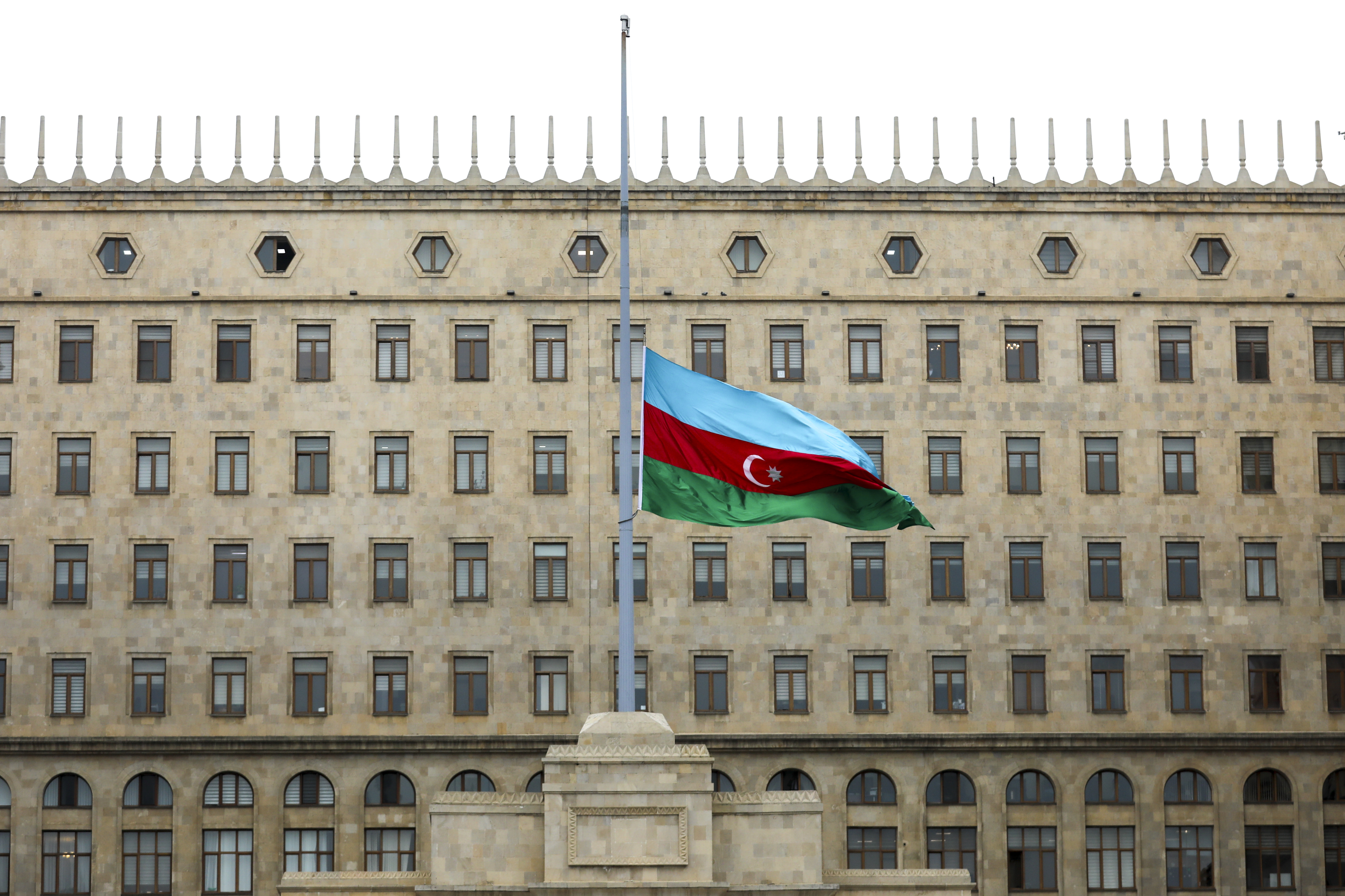 Azerbaijan’s flag, outside government building, at half-staff in memory of air crash victims, Baku, Azerbaijan, Dec. 26, 2024. (AP Photo/Aziz Karimov)