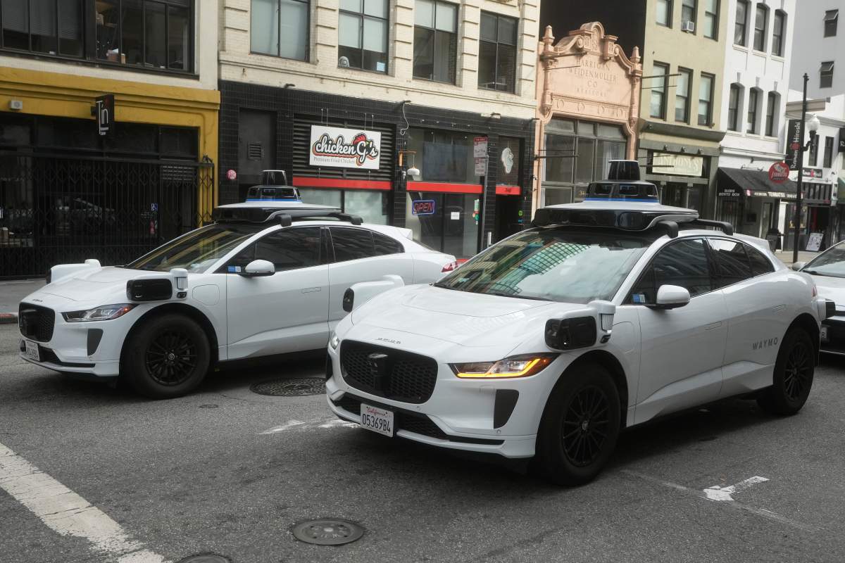 Waymo vehicles wait at an intersection in San Francisco, Wednesday, Oct. 22, 2025.