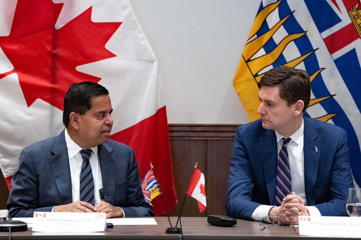 Public Safety Gary Anandasangaree, left, and B.C. Premier David Eby discuss the province's extortion crisis, Surrey, B.C., Nov. 28, 2025.