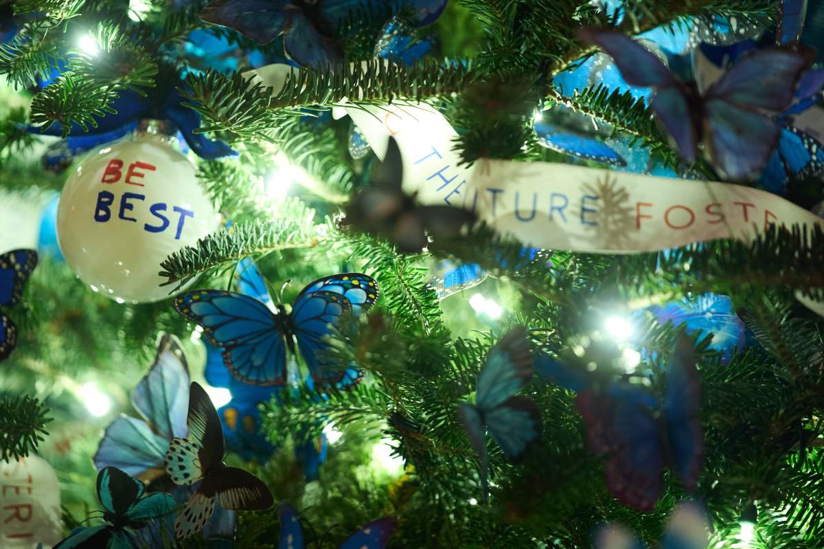 Ornaments hang from a Christmas tree in the Red Room of the White House during a press preview of the Christmas decorations 'Home is Where the Heart Is,' Monday, Dec. 1, 2025, in Washington.