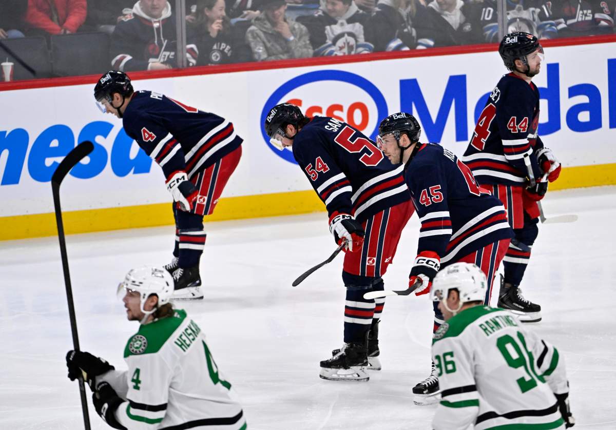 Winnipeg Jets' Neal Pionk (4), Dylan Samberg (54) and Cole Koepke (45) head back to the bench after a goal by Dallas Stars' Jason Robertson during the third period of their NHL hockey game in Winnipeg, Tuesday, Dec. 9, 2025. THE CANADIAN PRESS/Fred Greenslade.