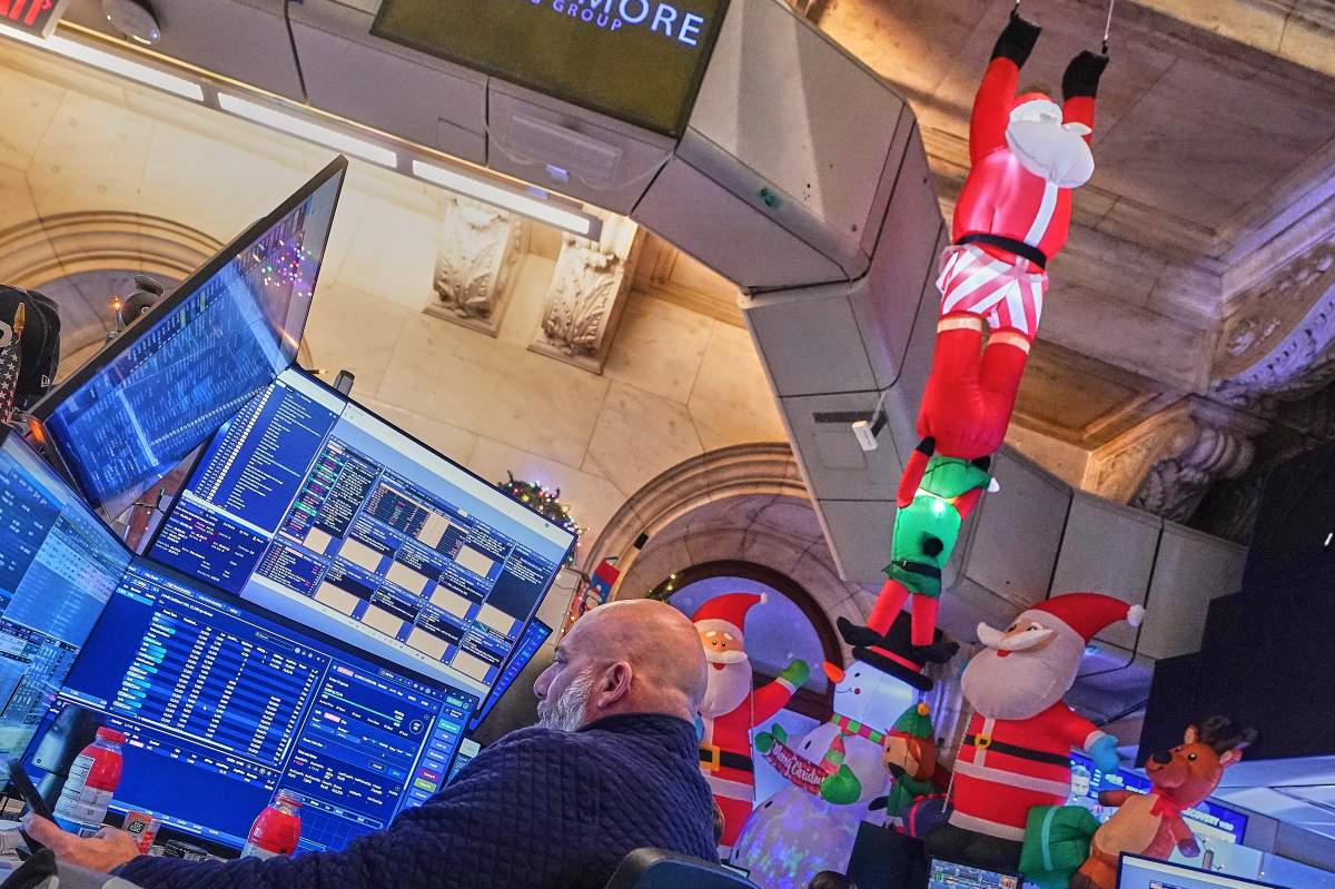 Trader Vincent Vincent Napolitano, surrounded by holiday decorations, works on the floor of the New York Stock Exchange on Dec. 11, 2025. (AP Photo/Richard Drew).