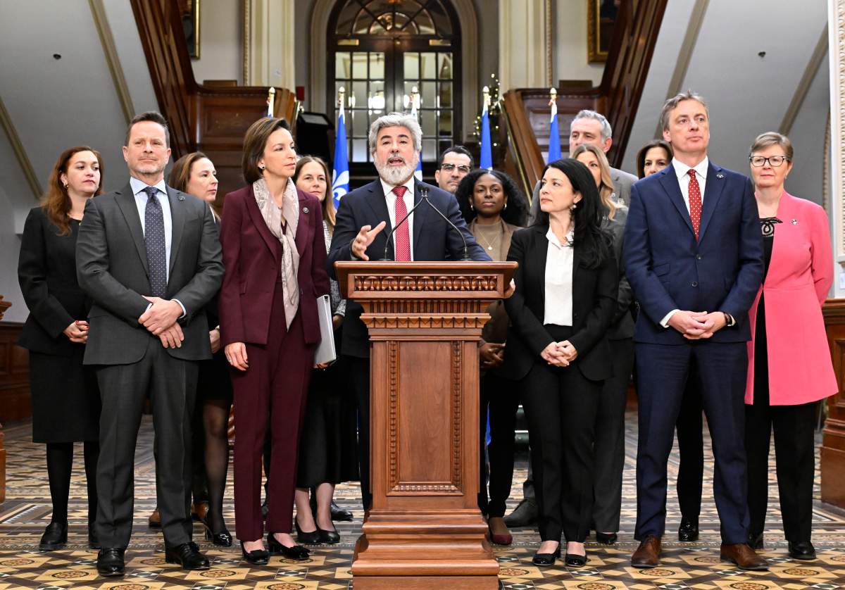 Quebec Liberal Leader Pablo Rodriguez stands with the Liberal caucus as he speaks during a news conference marking the end of the fall session at the legislature in Quebec City, Friday, Dec. 12, 2025. Liberal MNAs Elisabeth Press, from the left, Frederic Beauchemin, Desiree McGRaw, Michelle Setlakwe, Virginie Dufour, Leader Pablo Rodriguez, Monsef Derraji, Madwa-Nika Cadet, Filomena Rotiroti, Jennifer Maccarone, Enrico Ciccone, Brigitte Garceau, Marc Tanguay and Linda Caron.