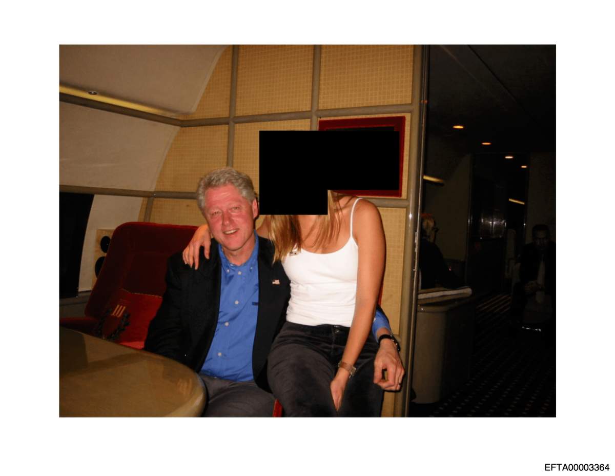This undated, redacted photo released by the U.S. Department of Justice shows former President Bill Clinton with an unknown person. (U.S. Department of Justice via AP)