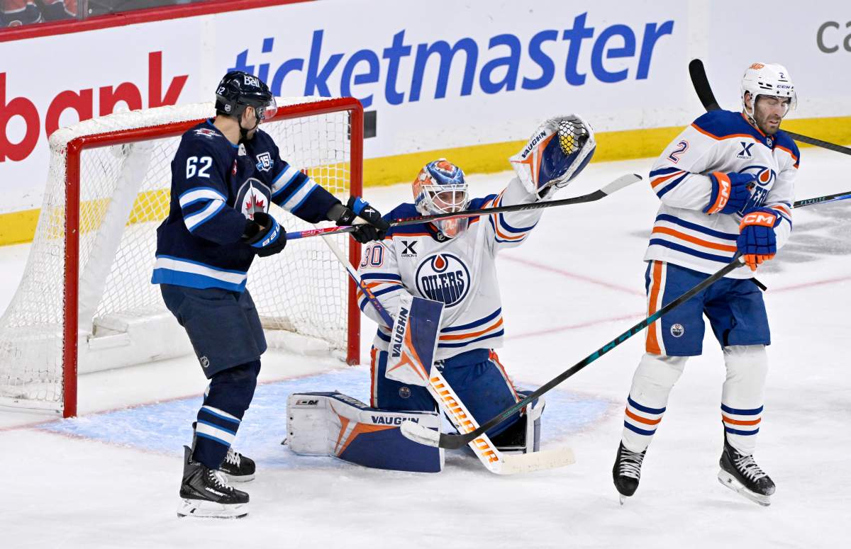 Edmonton Oilers goaltender Calvin Pickard (30) makes a save as Winnipeg Jets' Nino Niederreiter (62) looks for the deflection during third period NHL action in Winnipeg on Monday December 29, 2025. THE CANADIAN PRESS/Fred Greenslade.
