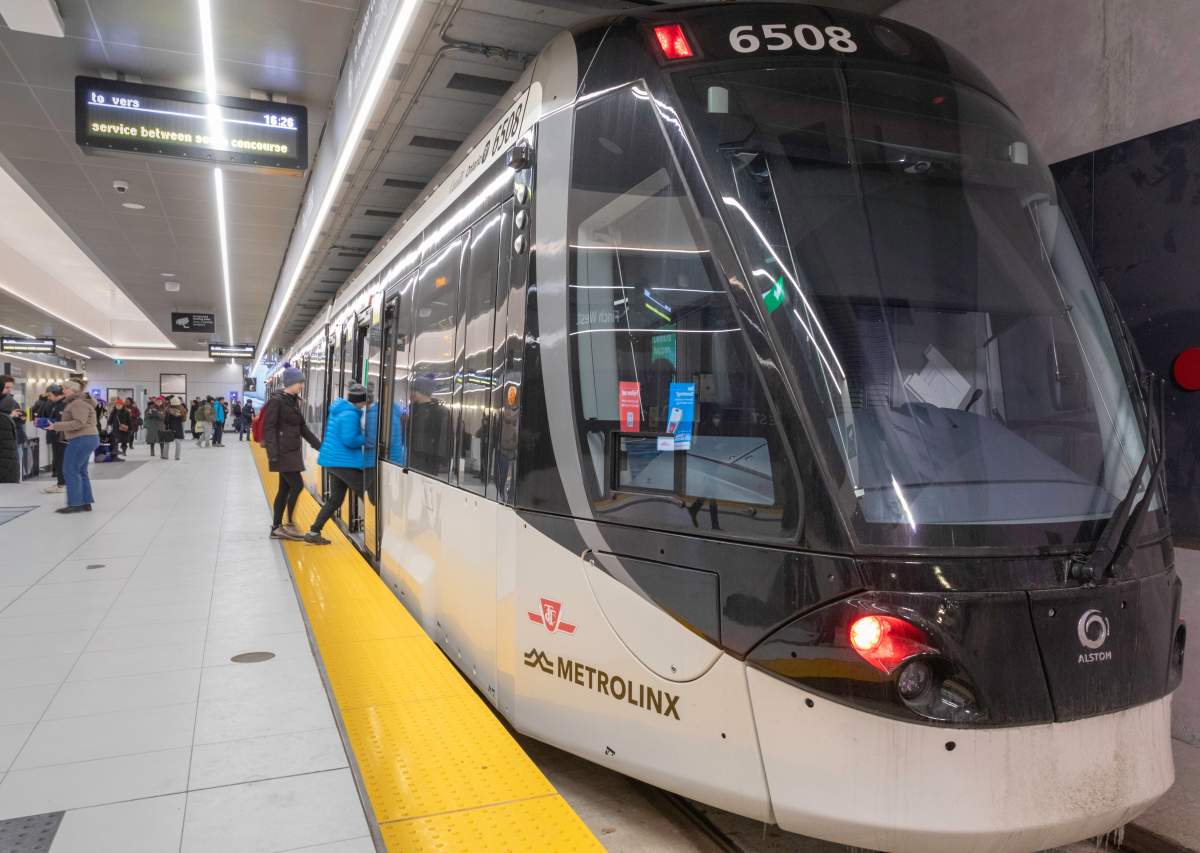 Passengers prepare to board a streetcar on opening day for Line 6 at the Finch West station in northwest Toronto on Sunday, Dec. 7, 2025. The $3.7-billion light rail line runs 10.3 kilometres between the station and Humber College to the west.