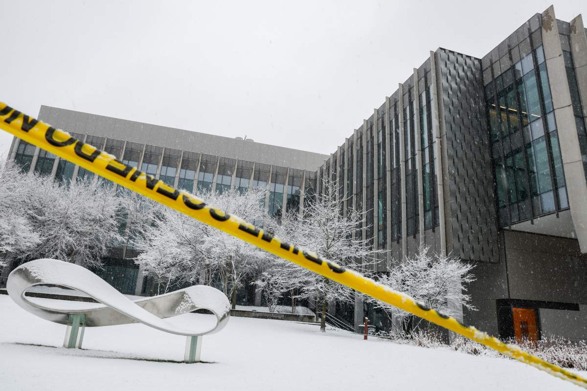 Police caution tape surrounds Brown University's Barus and Holley building Dec. 14, 2025, after a shooting on Saturday in Providence, R.I.