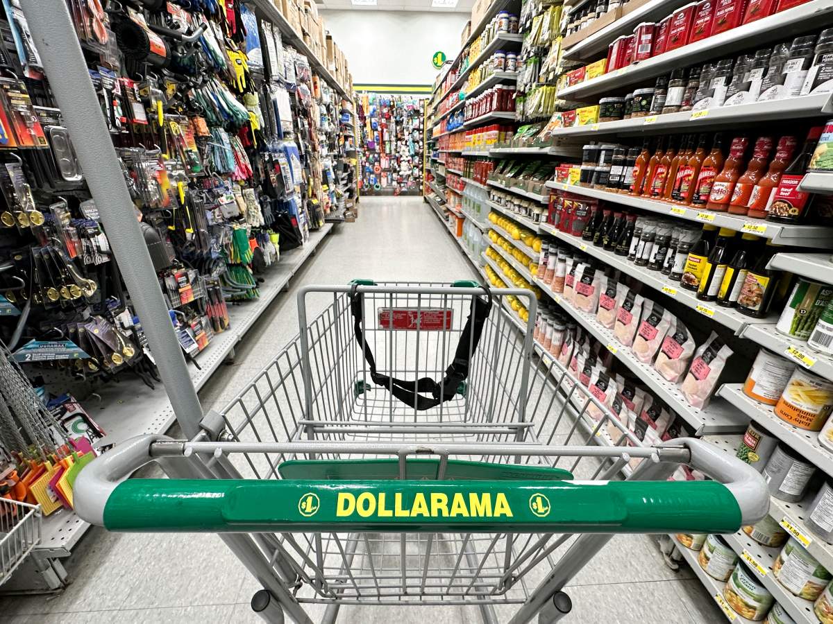 A shopping cart is seen in an aisle of a Dollarama store in Montreal, Wednesday, June 7, 2023.