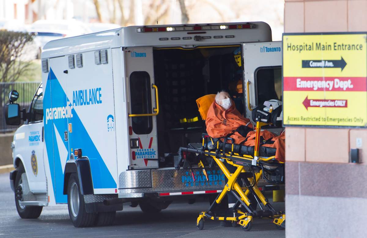 A paramedic transports an elderly man to the emergency department at a hospital in Toronto on Wednesday, April 22, 2020.