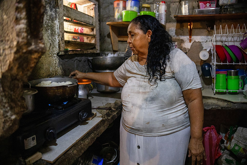 Carmela Medina, mother of Alejandro Carranza, a Colombian man who allegedly died when the US bombed a boat supposedly carrying drugs in the Caribbean, cooks in her kitchen in Santa Marta on October 21, 2025.