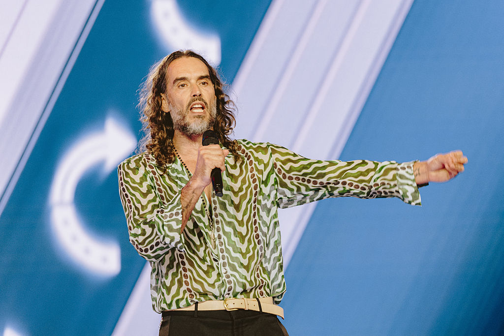 English comedian and actor Russell Brand speaks during Turning Point's annual AmericaFest conference, in remembrance of late right-wing political activist Charlie Kirk, in Phoenix, Arizona on December 18, 2025.
