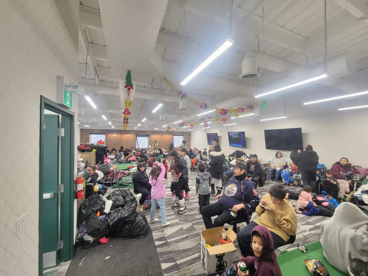 People gathering at the public works building in Pimicikamak to be busses to Thompson. 