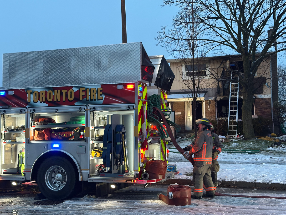 Firefighters on the scene of a fire in Toronto on the morning of Dec. 23, 2025.