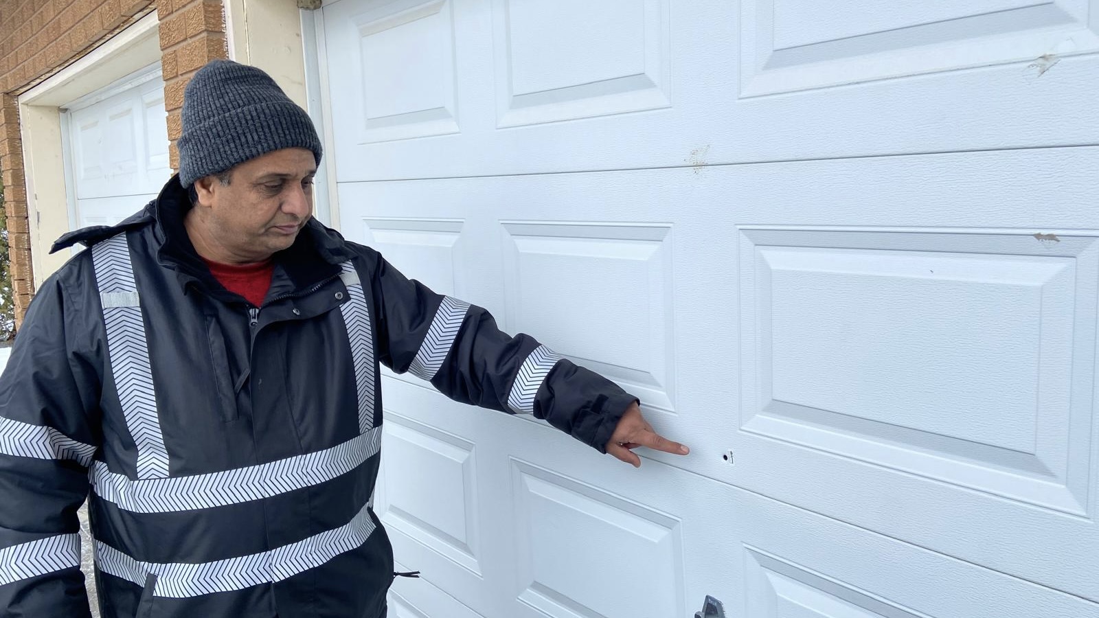 Dharmjit Mand shows where bullet struck his garage in Caledon, Ont., on Nov. 25, 2025.