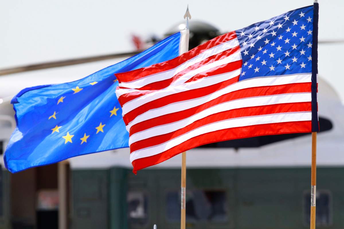 The U.S. and European Union flags wave at Dulles International Airport in Chantilly, Va.