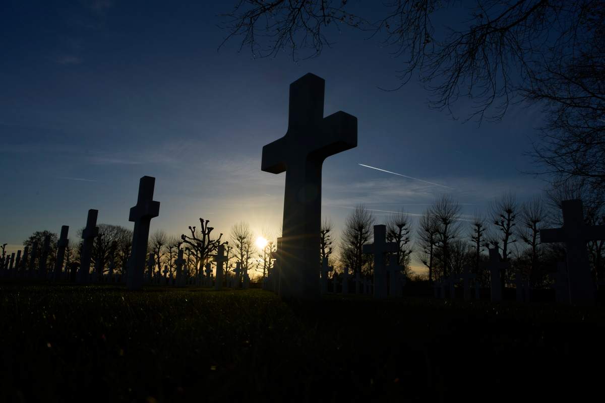 The sun sets over the graves of more than 8.300 WWII soldiers at the Netherlands American Cemetery in Margraten, Netherlands, Thursday, Dec. 11, 2025, where the American Battle Monuments Commission removed two displays honoring Black liberators from the visitors center.