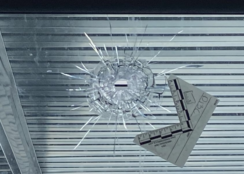 Bullet hole in window which Dharmjit Mand said was part of an extortion attempt by India's Bishnoi gang.