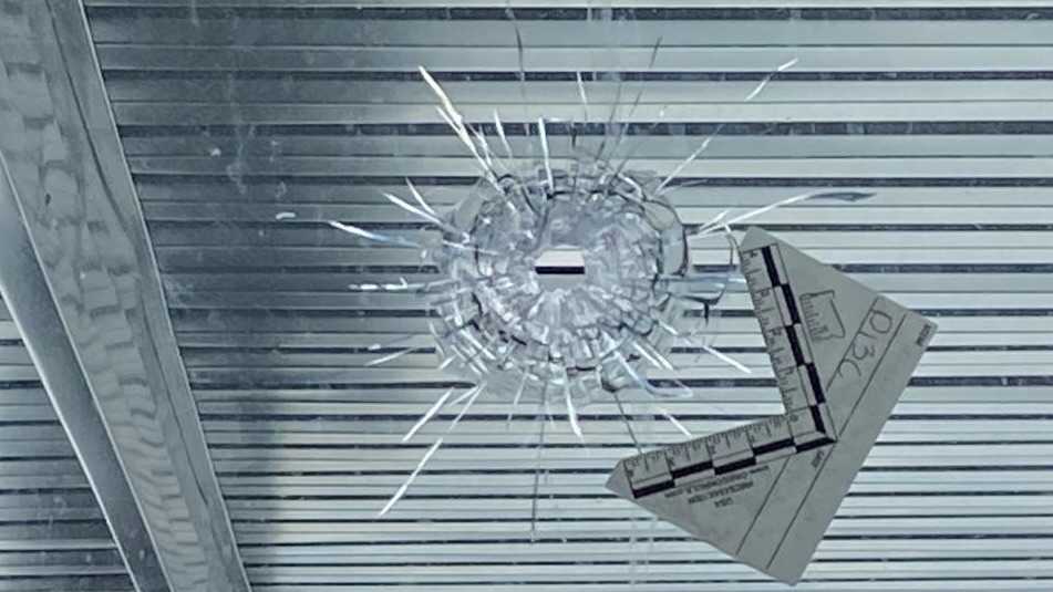 Bullet hole in glass which Dharmjit Mand said was part of an extortion attempt against him.