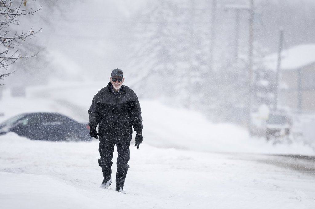 A resident of Cremona, Alta., trudges through snow on Monday, Nov. 24, 2025.