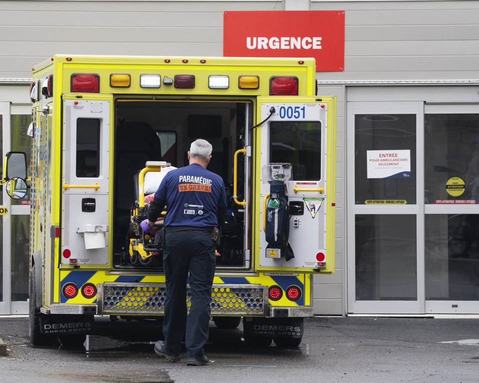 A paramedic loads his stretcher back into the ambulance after bringing a patient to the emergency room at a hospital in Montreal, Thursday, April 14, 2022. 