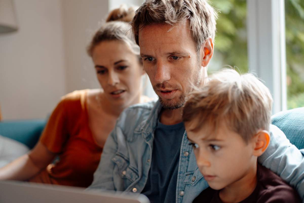A family reads a shocking email on a laptop.