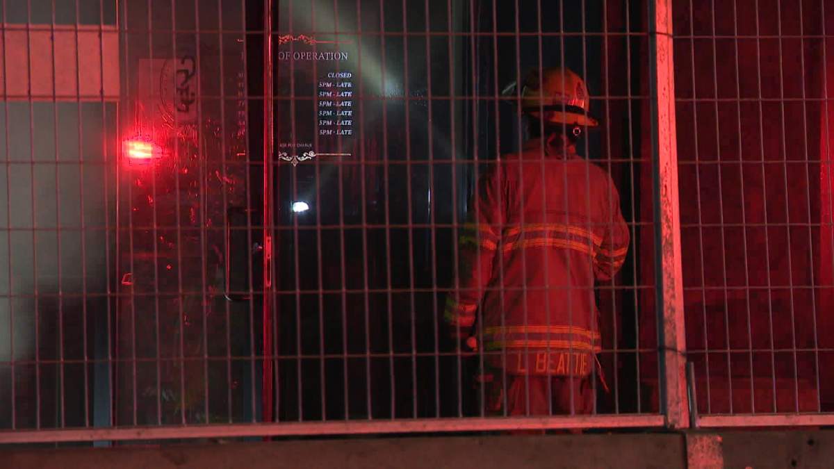 Calgary fire crews could be seen using flashlights and other hand tools to search for the source of the smouldering fire that broke out around 5 a.m. on Wednesday at a restaurant in the Beltline.