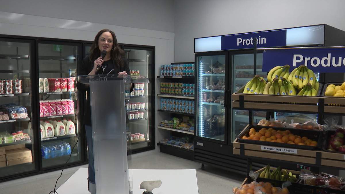 The President of the Calgary food bank, Melissa From, speaks at the official opening of the food bank's new location in downtown Calgary on Monday.