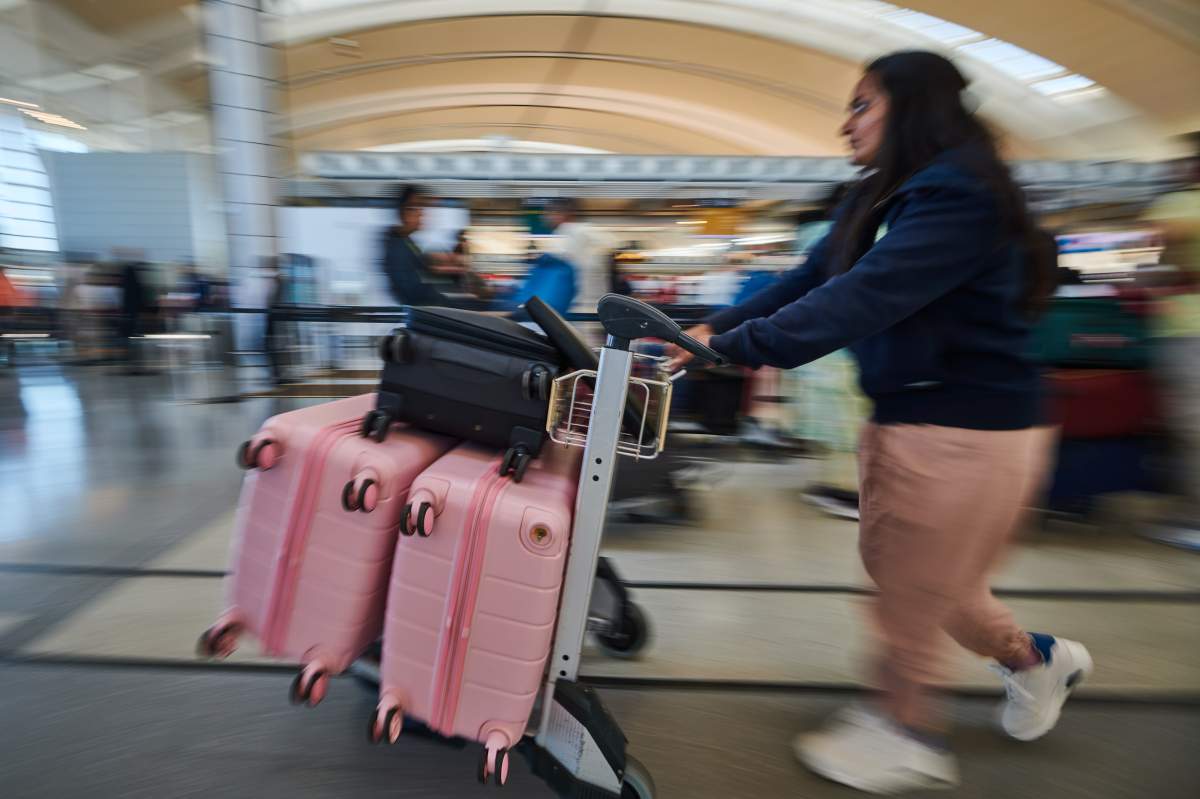 Travellers pass by the Air Canada departure gate at Pearson International Airport.