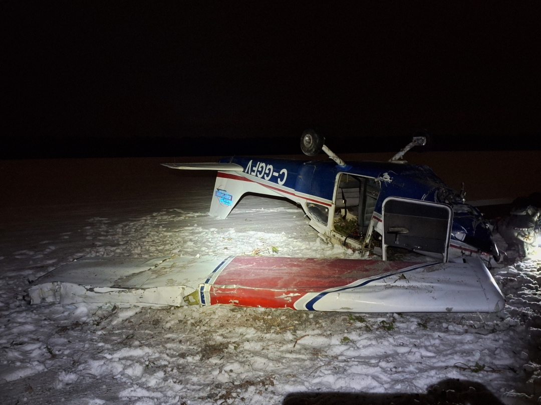 A Cessna 172N plane sits on its back near Sarnia Chris Hadfield Airport on Friday, Dec. 12, 2025 after it crashed. The pilot suffereed non-life-threatening injuries and was treated in hospital.