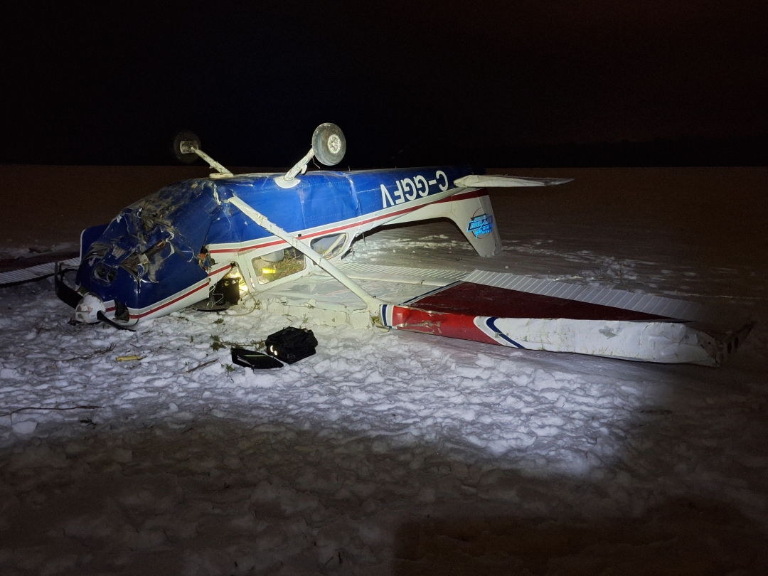 A Cessna 172N plane sits on its back near Sarnia Chris Hadfield Airport on Friday, Dec. 12, 2025 after it crashed.