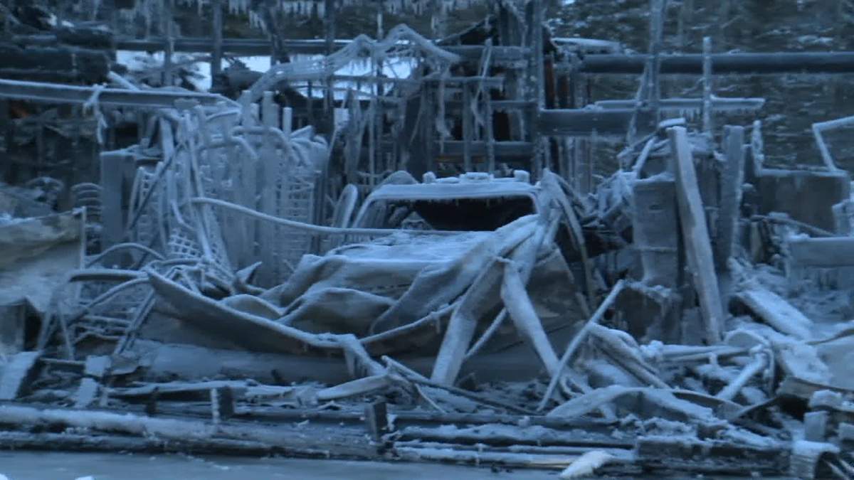The blackened remains of one of the Redwood Meadows firetrucks sits in the middle of a pile of charred wood and twisted metal left behind by the Wed. night fire.