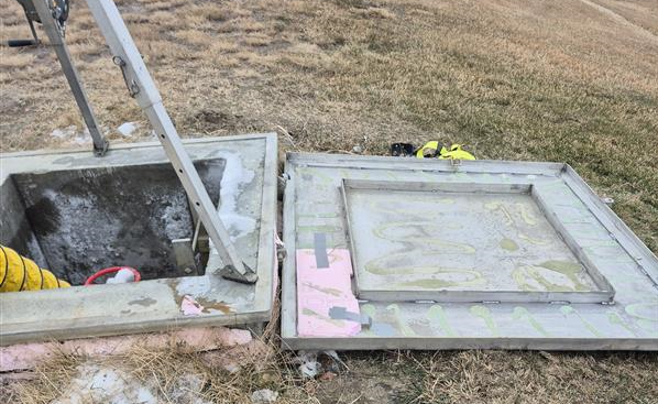 The reservoir hatch that was tampered with in Outlook, Sask. sits open as it's inspected by officials. The hatch was not found wide open as pictured when the tampering occurred. 